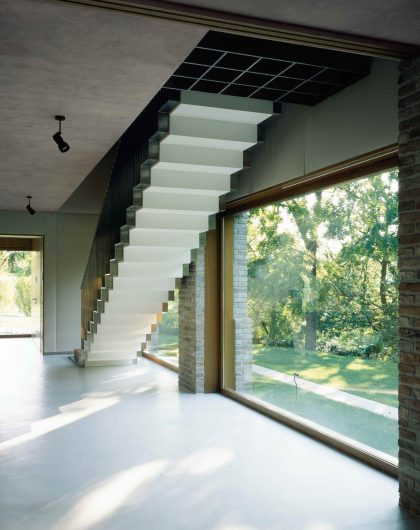 Internal view of the staircase with natural effect oak fixed windows