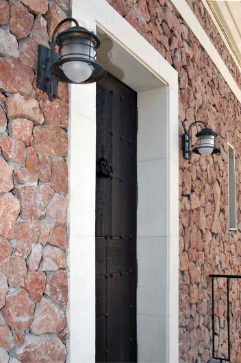 Detail view of a blind wooden door with bronze details