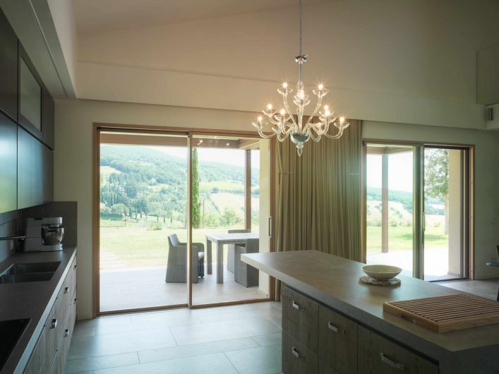 View of the lift and sliding door with two doors in the kitchen area of Villa Pisa