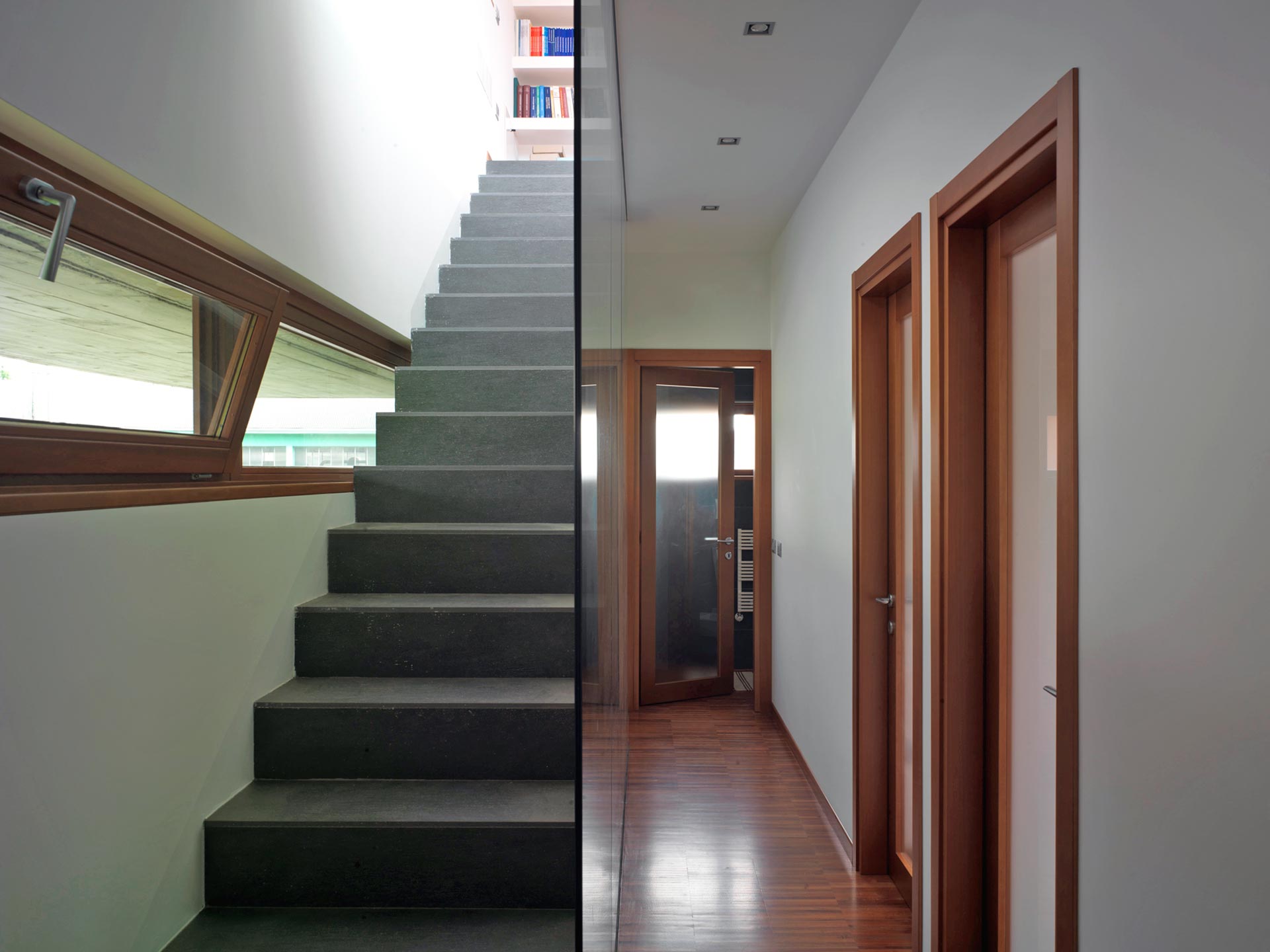 View of a corridor and a staircase with ribbon bottom hung windows