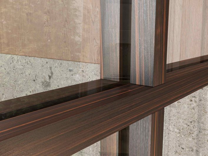 Detail of the Lady sliding door in mahogany with crosspieces and transparent glass