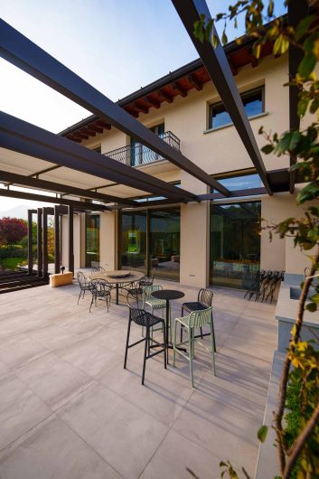 External terrace of Villa Vertova with metal structure and motorized blind