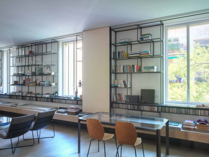 View of the custom bookcase wall from the Firenze Art Studio, with three white lacquered Skyline windows