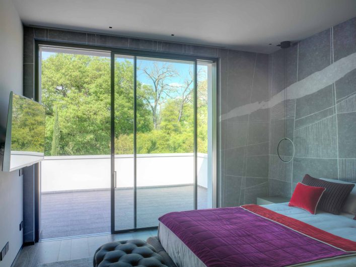 View of the master bedroom of Villa Arezzo with Skyline Sliding lift and slide